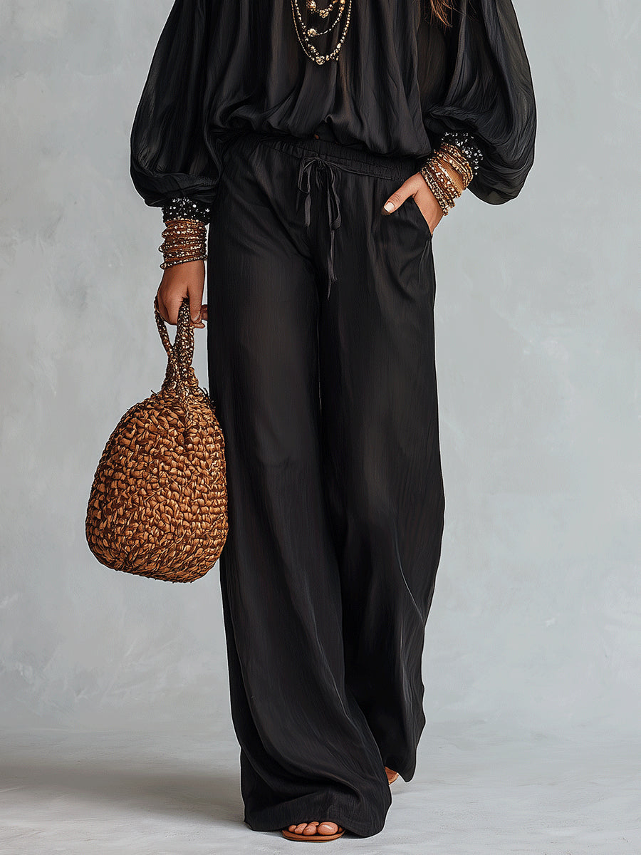 Top Nero Con Paillettes Senza Spalline Abbinato A Pantaloni Larghi Con Coulisse