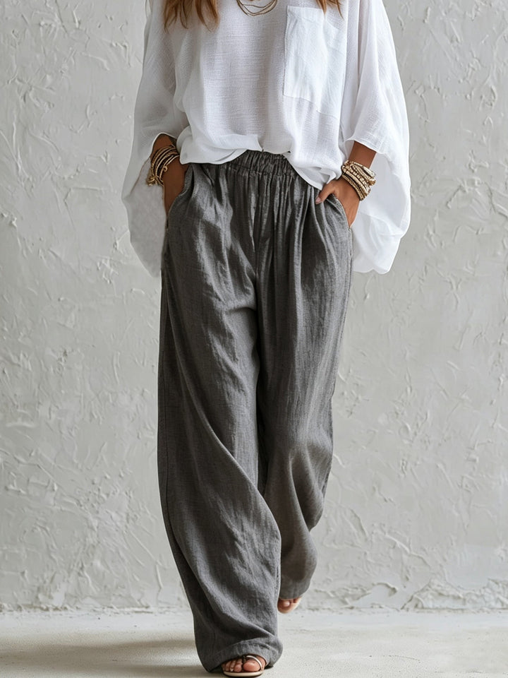 Completo con Top Bianco Lungo e Pantaloni Grigi a Vita Elastica a Gamba Larga